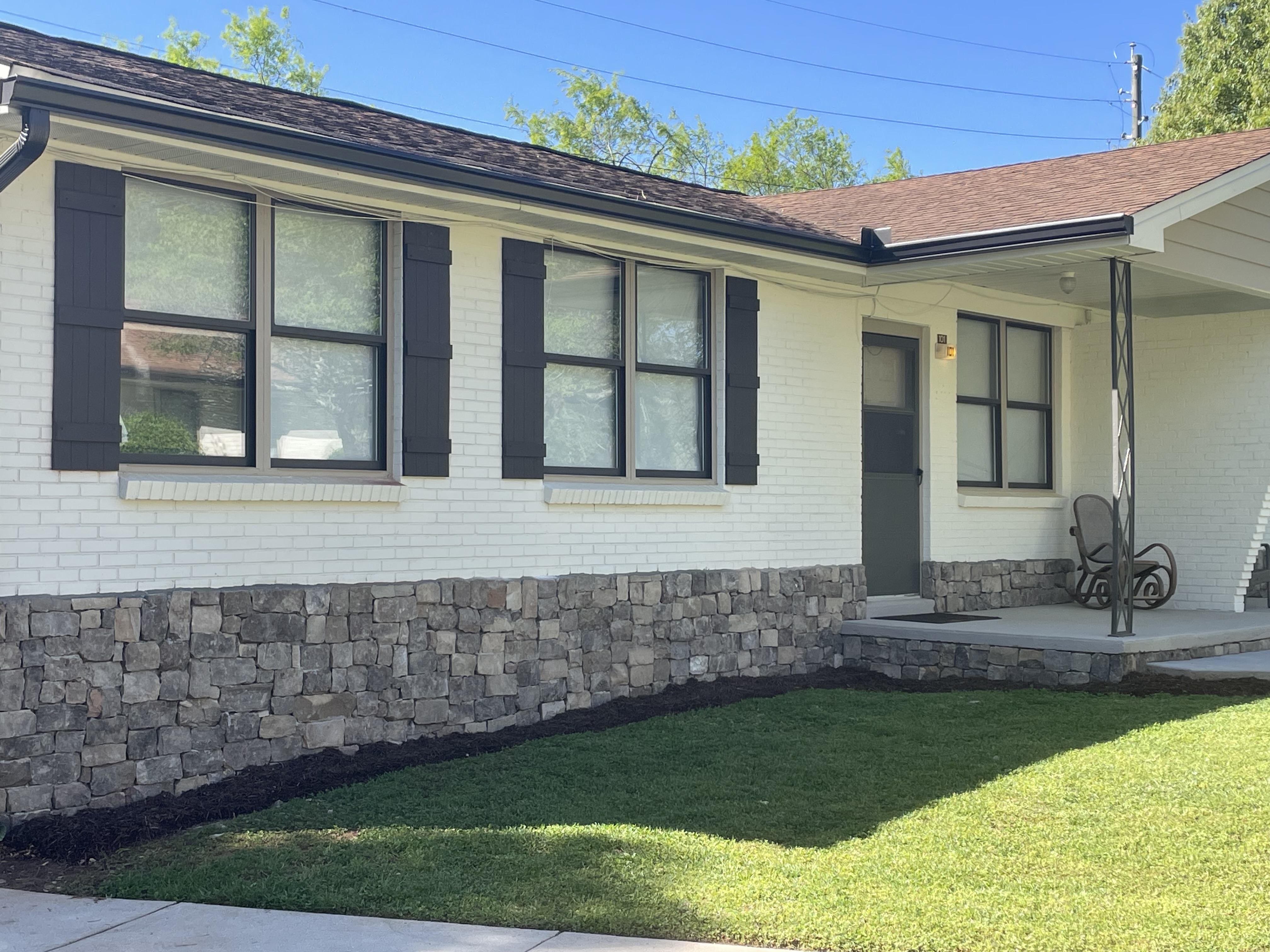 Shows the entrance to a brick style row house